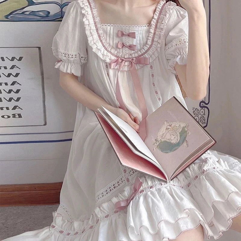 Detail shot of layered pink ribbon bows and satin bow on princess lace nightgown