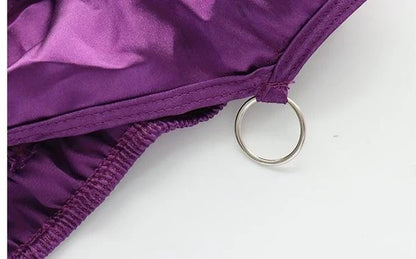Close up of metal O ring hardware and purple fabric texture on Halloween set