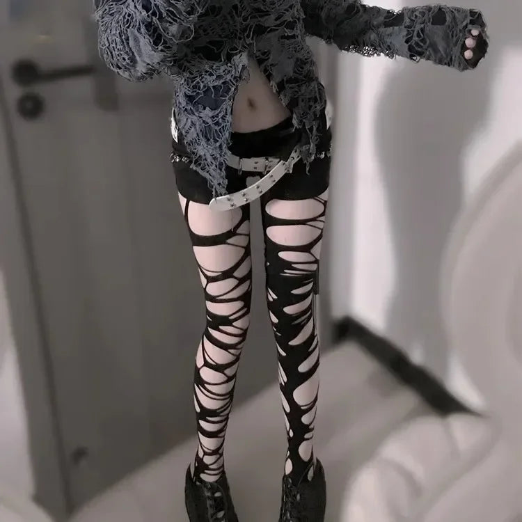 Black ripped web tights styled for a dark gothic punk alternative outfit