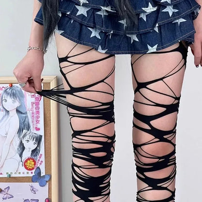 Ripped web tights styled with a mini skirt and boots for punk grunge outfit