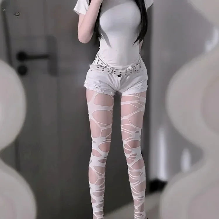 Full length view of white ripped web alternative tights showing shredded design