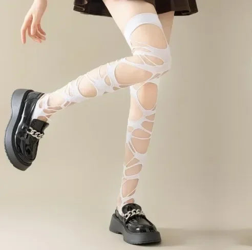 White ripped web tights styled as over knee stockings for a light contrast alt look