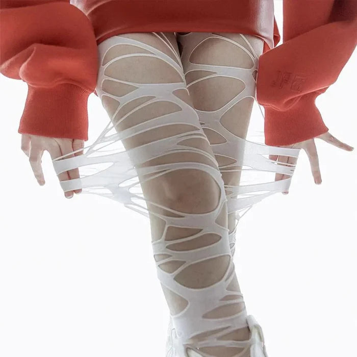 Close up of web cutout pattern on white Ripped Web Brat Alternative Tights