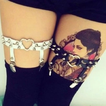 White and black Spiked Rebel Heart Garters worn on both legs for edgy style