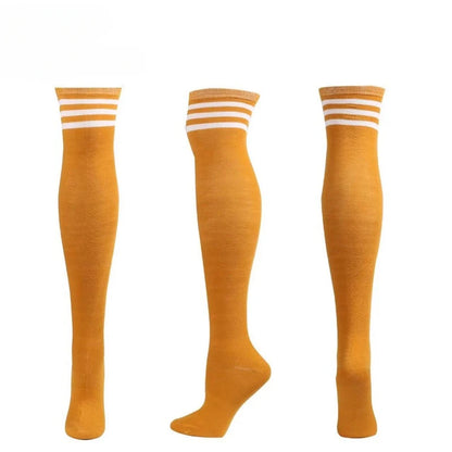 Playful orange and white striped thigh-high stockings for pastelcore and cute baddie looks