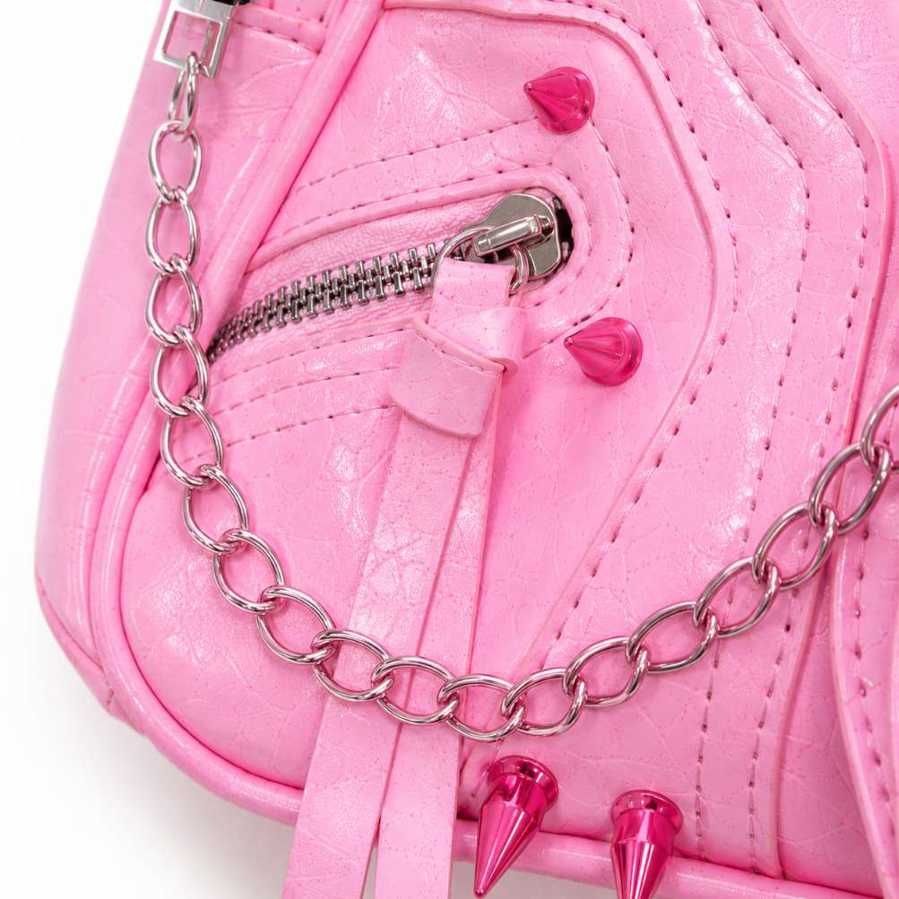 Detail shot of statement cone spikes covering the baby pink kawaii punk shoulder bag
