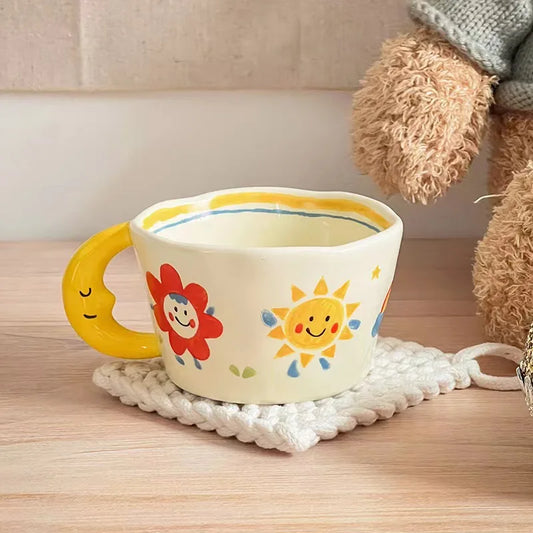 Cute pastel mug with smiling sun, flower art, and crescent moon handle for kawaii DDLG ABDL vibes