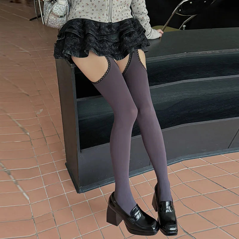 Soft grey thigh-high stockings with delicate lace cut-outs, blending neutral vibes with bratty attitude.