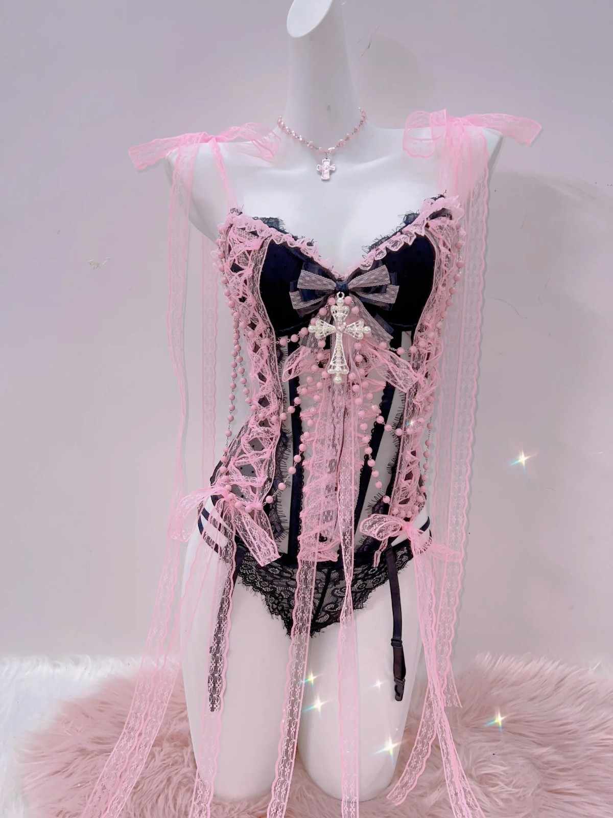 Temptation pink lace lingerie set featuring delicate bows and sultry sheer stripe design.