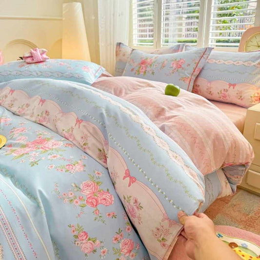 Victorian bedding set with blue base, pink floral embroidery, and delicate bow tie accents for kawaii vintage bedroom decor