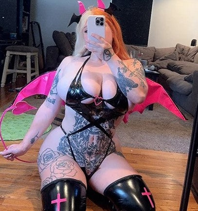 Wicked Temptress lingerie set in fuchsia and black for cosplay baddies, featuring lace-up bodysuit, devil tail, heart hollow chest, horns, and wings