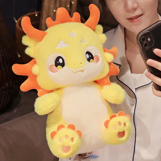 Soft yellow-orange kawaii dragon plush toy with vibrant colors and cuddly fabric.
